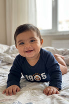 Galatasaray Bio-Babybody Langarm – Sarı Kırmızı – Baby trägt den Body